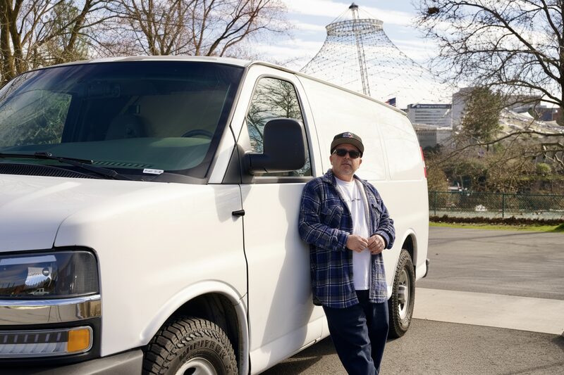 Greg, locksmith and automotive specialist at Precision Lock & Key, next to the work van