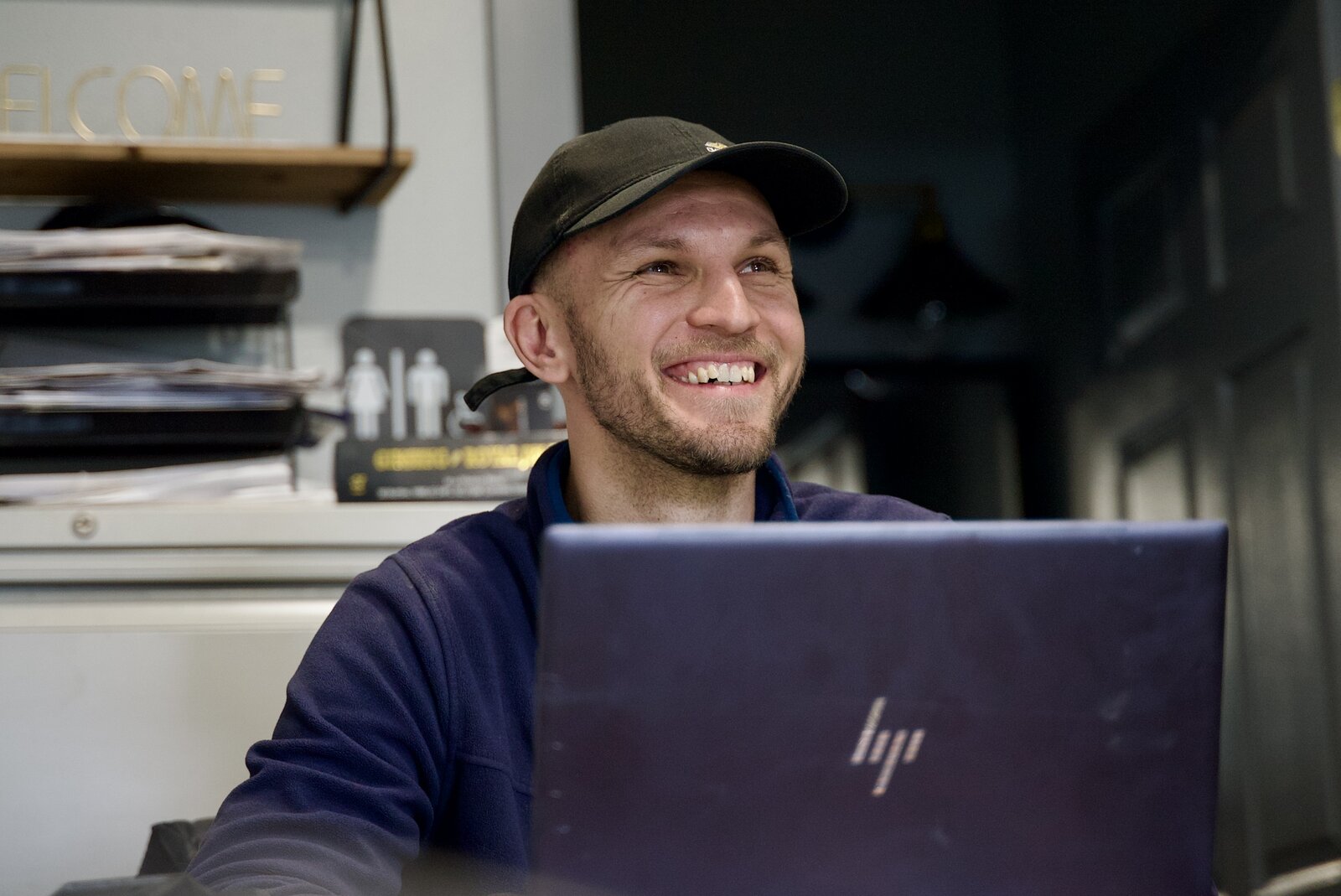 Alex, owner of Provision Auto Sales and Repair, smiling at his desk