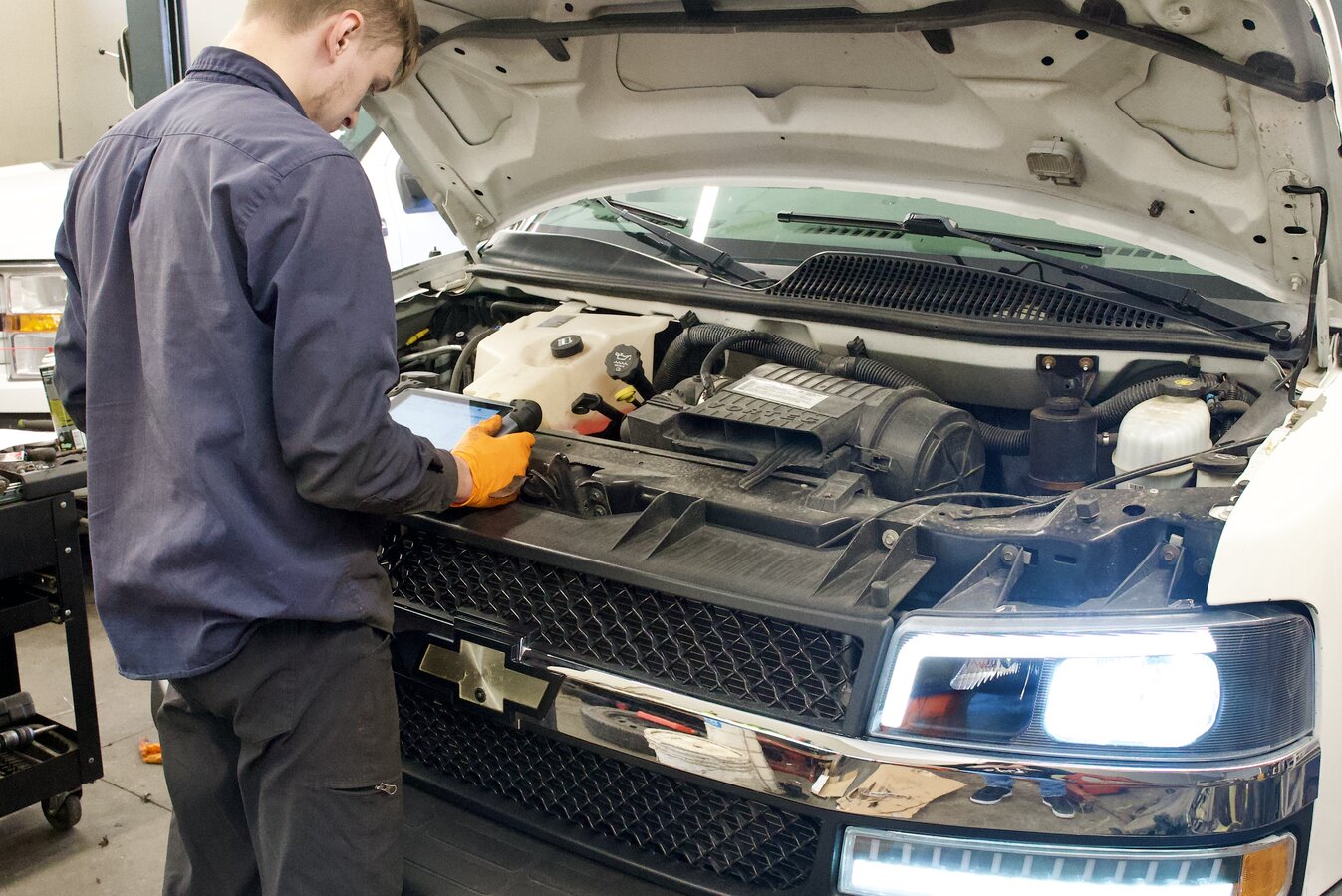 Mechanic at Provision Auto diagnosing Precision Lock & Key service van engine
