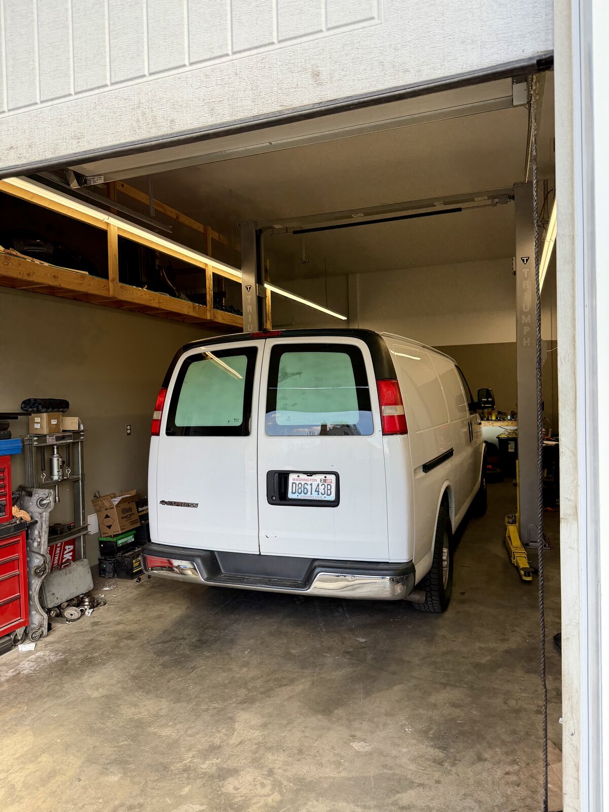 Precision Lock & Key Chevy Express service van parked in Provision Auto garage