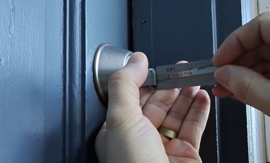 Precision Lock & Key locksmith picking a door lock in Spokane, WA