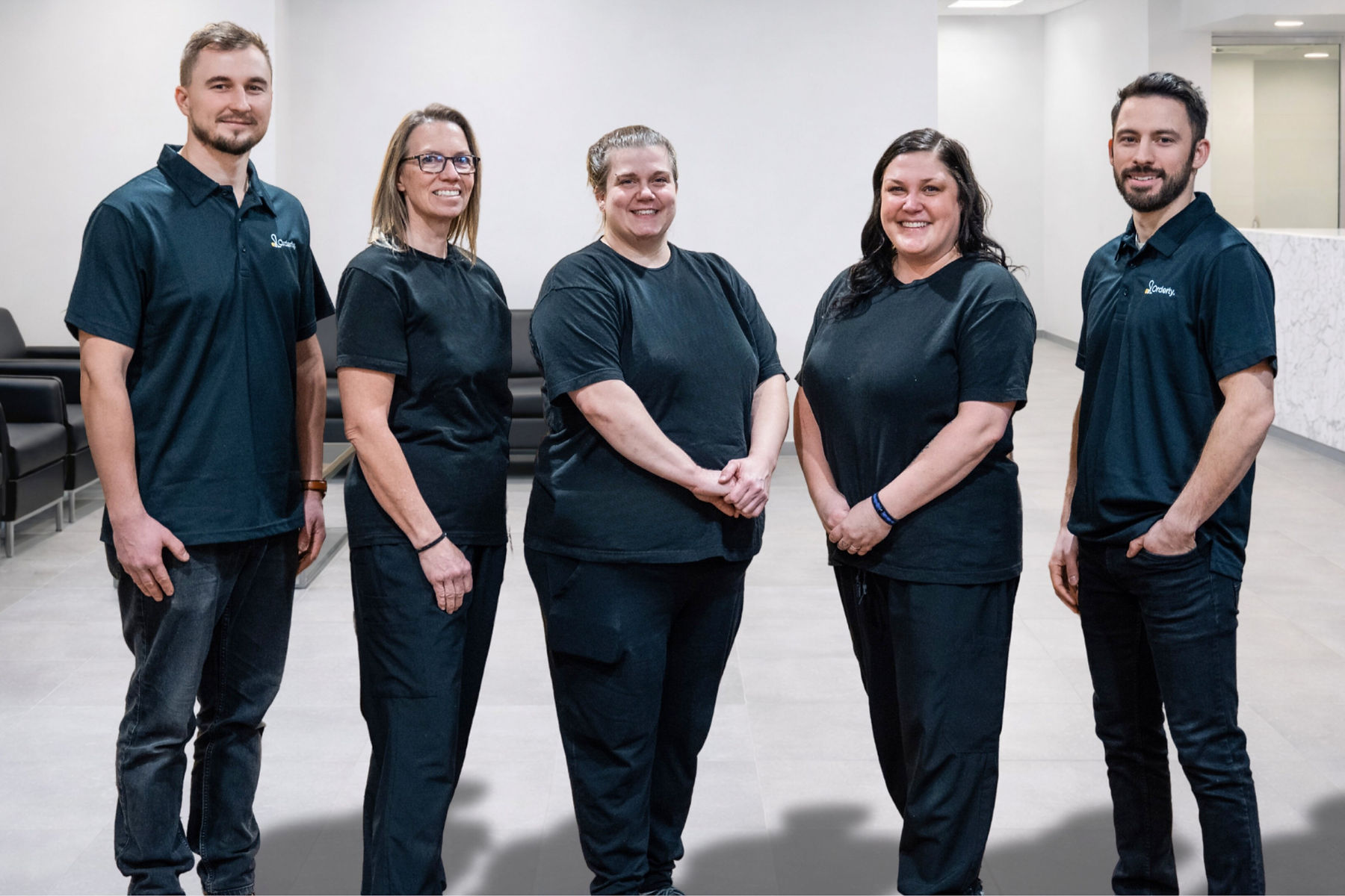 Orderly cleaning team group photo in branded uniforms